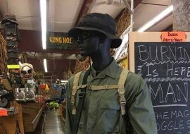 store model hold a condor bag with a bucket hat and army green jacket