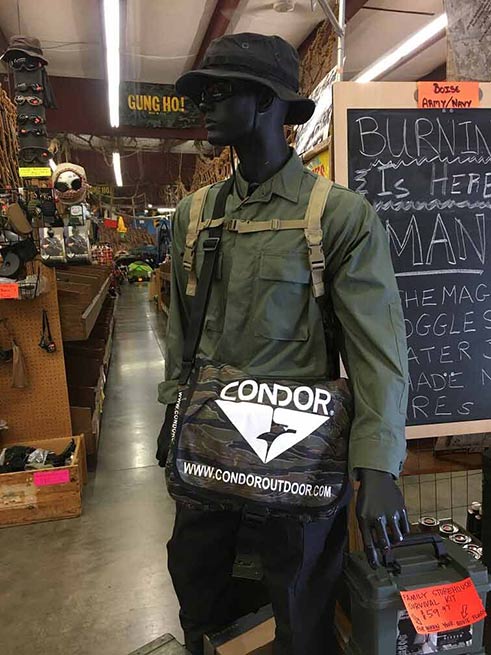 store model hold a condor bag with a bucket hat and army green jacket